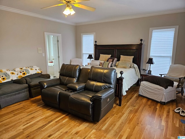 bedroom featuring light hardwood / wood-style floors, ornamental molding, ensuite bath, and ceiling fan