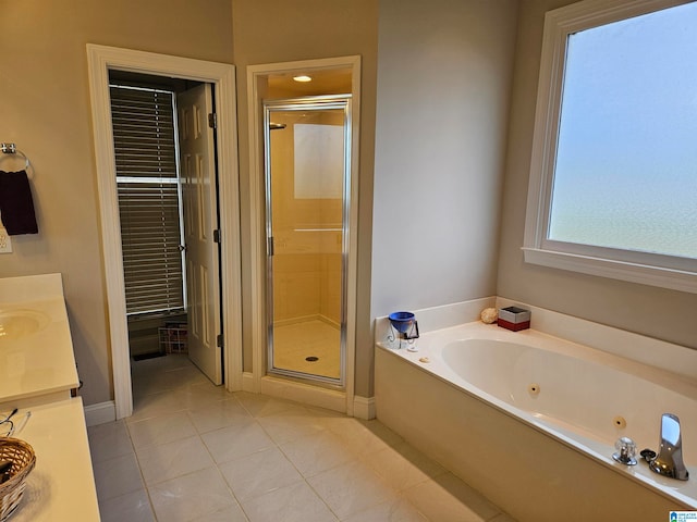 bathroom with vanity, plus walk in shower, and tile patterned flooring