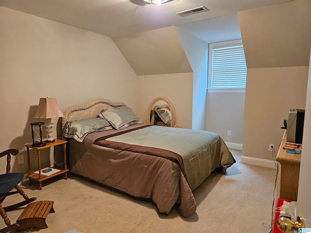 bedroom featuring lofted ceiling and light colored carpet