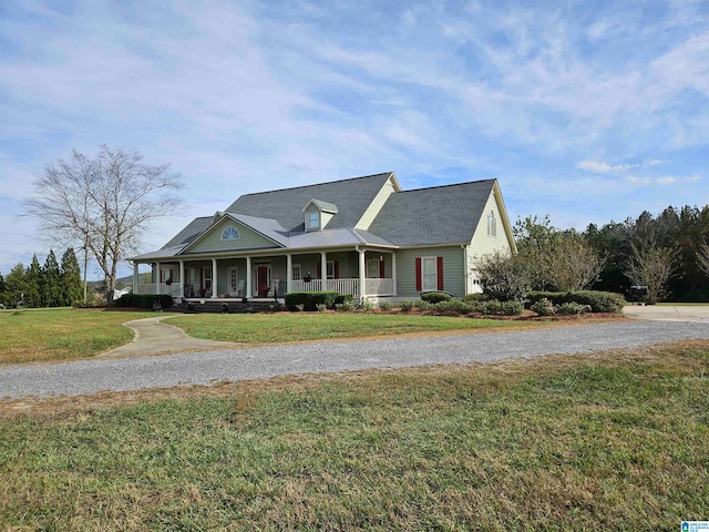 country-style home featuring a front lawn and a porch