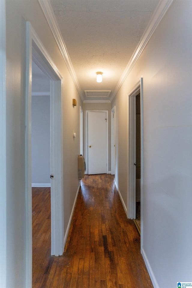 corridor with dark hardwood / wood-style floors and ornamental molding