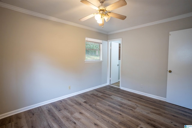 spare room with ceiling fan, dark hardwood / wood-style flooring, and crown molding