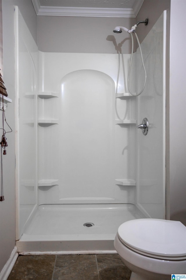 bathroom featuring a shower, toilet, and crown molding