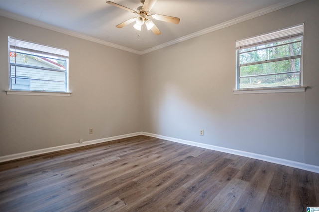 spare room with crown molding, ceiling fan, and dark wood-type flooring