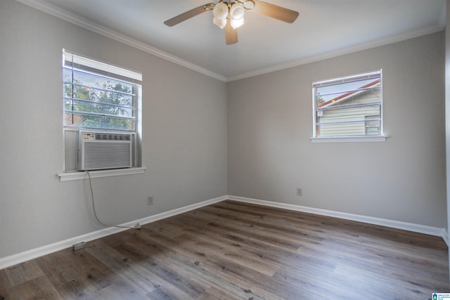 spare room featuring ornamental molding, plenty of natural light, dark wood-type flooring, and ceiling fan