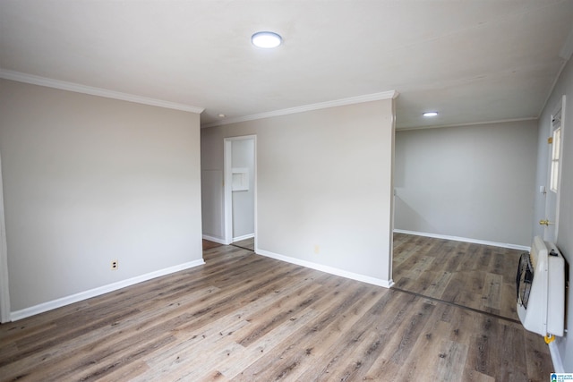 unfurnished room with dark hardwood / wood-style floors, crown molding, and heating unit