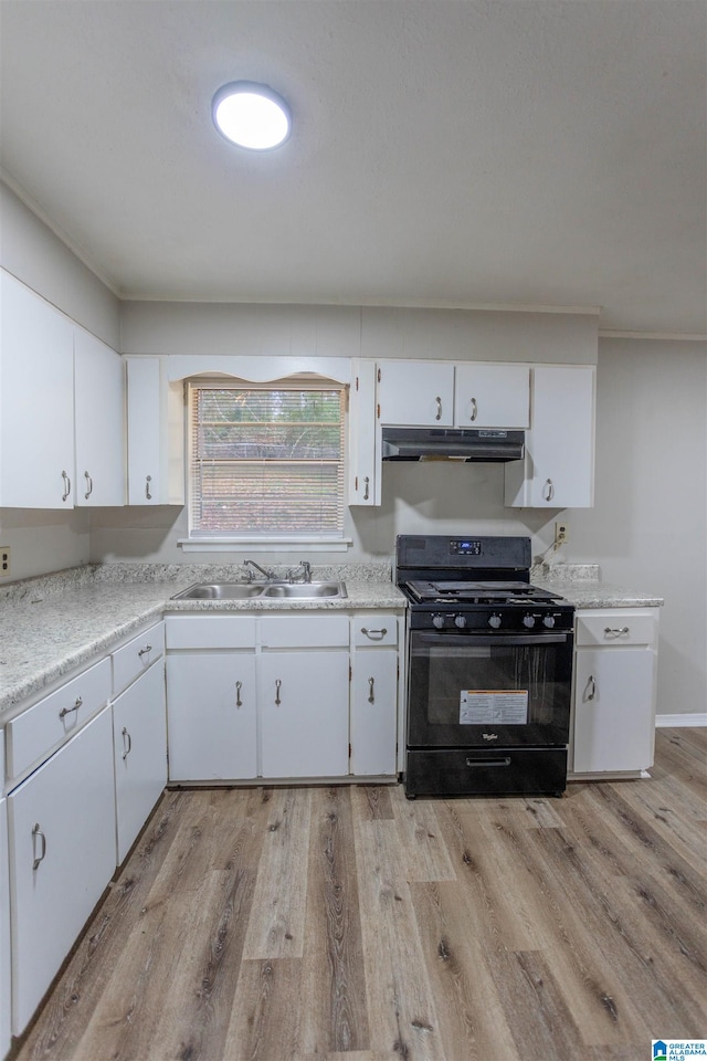 kitchen with white cabinetry, light hardwood / wood-style flooring, black gas range oven, and sink