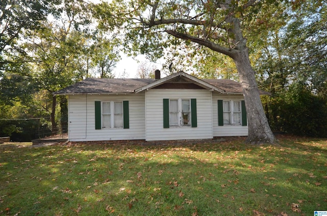 view of side of home with a lawn