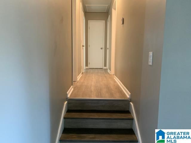 staircase with hardwood / wood-style floors