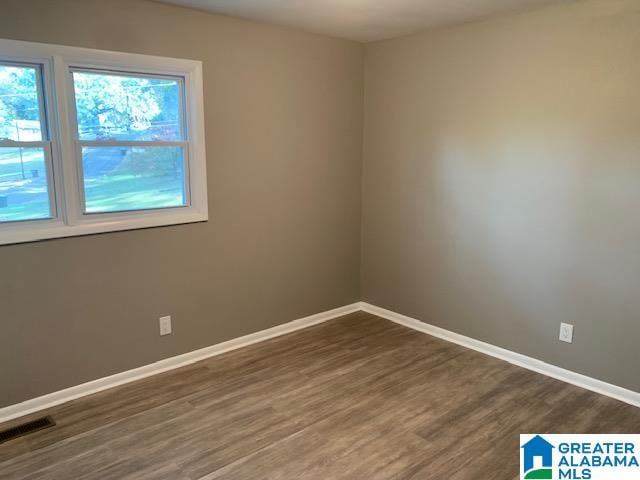 spare room featuring dark hardwood / wood-style flooring