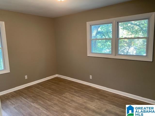 spare room with dark hardwood / wood-style floors