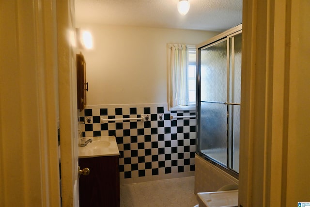477 County Road 183, Eutaw, AL 35462 - full bathroom featuring an enclosed shower, tile walls, vanity, tile patterned floors, and a textured ceiling