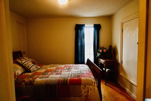 477 County Road 183, Eutaw, AL 35462 - bedroom featuring wood finished floors and a textured ceiling