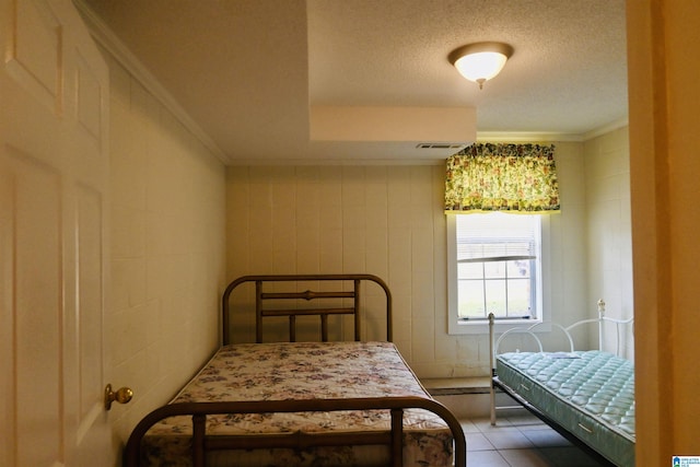 477 County Road 183, Eutaw, AL 35462 - bedroom with a textured ceiling, crown molding, and tile patterned flooring