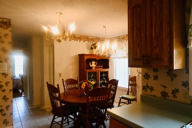 477 County Road 183, Eutaw, AL 35462 - dining room with a chandelier, light tile patterned flooring, and baseboards