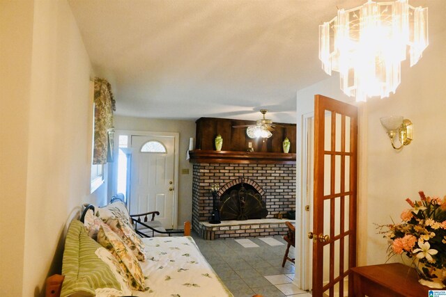 477 County Road 183, Eutaw, AL 35462 - living area with a brick fireplace, ceiling fan, and a chandelier