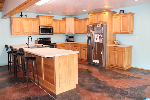 kitchen with stainless steel appliances, beamed ceiling, light brown cabinetry, a kitchen breakfast bar, and sink