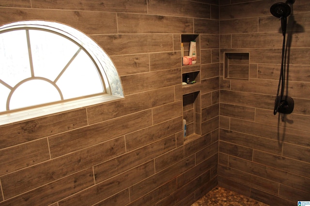 bathroom with tiled shower