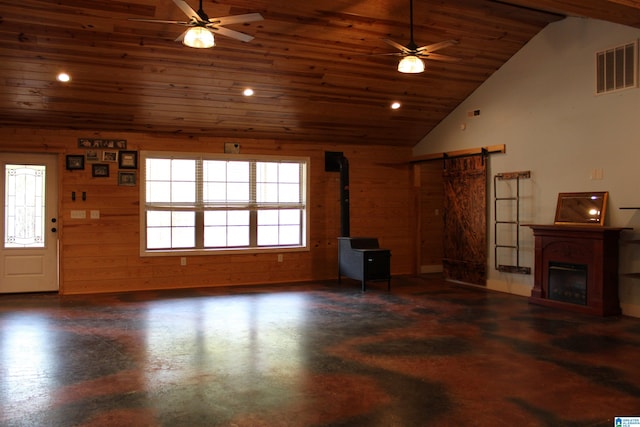 unfurnished living room with ceiling fan, wooden walls, a wood stove, and wooden ceiling