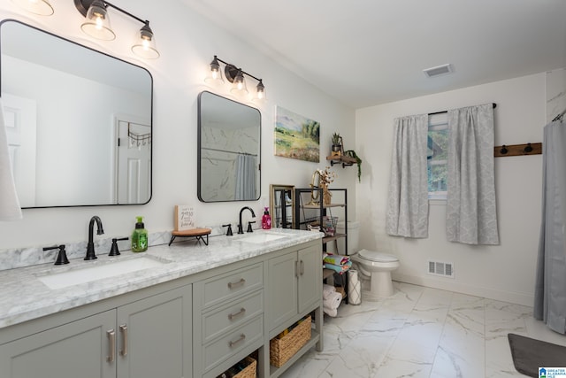 bathroom with vanity and toilet