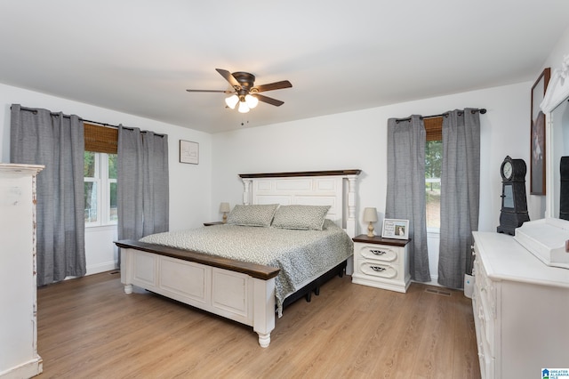 bedroom with light hardwood / wood-style flooring, multiple windows, and ceiling fan