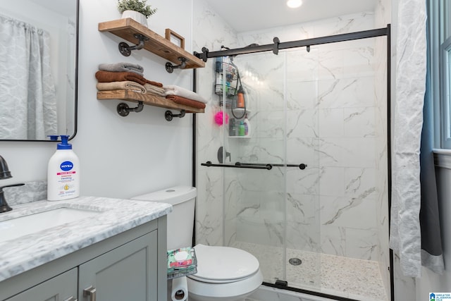 bathroom featuring vanity, toilet, and walk in shower