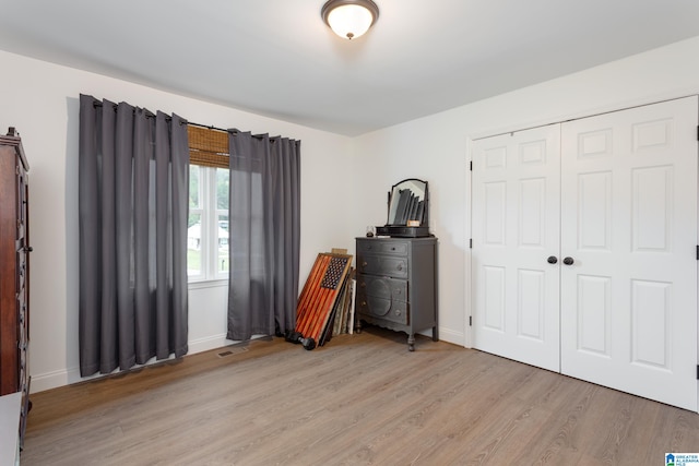 bedroom featuring a closet and light hardwood / wood-style flooring