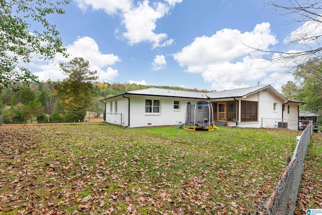 back of property featuring a yard, a sunroom, and central air condition unit