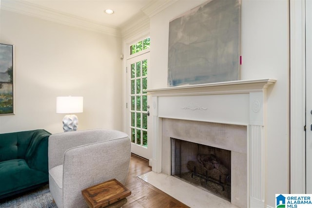 living room featuring ornamental molding, a high end fireplace, and hardwood / wood-style floors