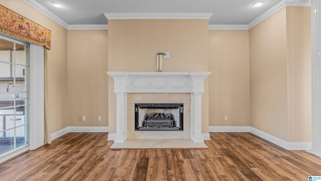 unfurnished living room featuring ornamental molding, hardwood / wood-style floors, and a textured ceiling