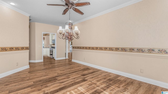 unfurnished dining area with wood-type flooring, ornamental molding, and ceiling fan with notable chandelier