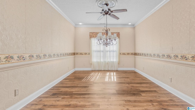 unfurnished room featuring crown molding, hardwood / wood-style floors, a textured ceiling, and ceiling fan with notable chandelier