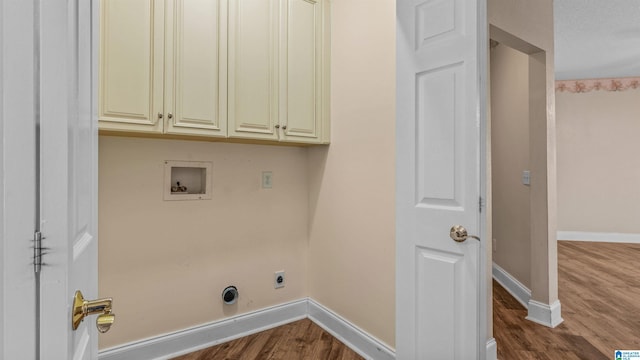 laundry room featuring hookup for an electric dryer, hardwood / wood-style flooring, washer hookup, and cabinets