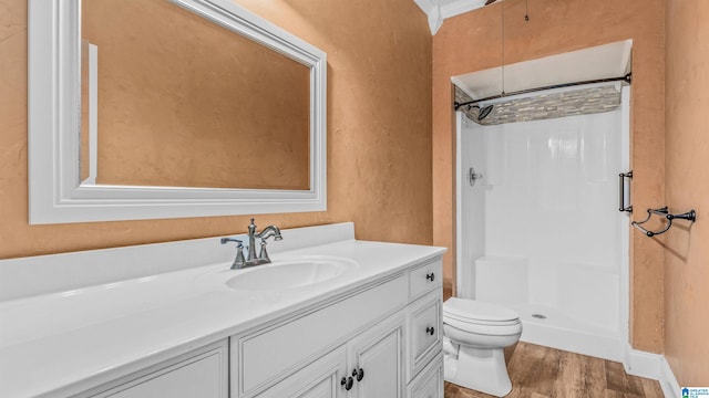 bathroom featuring toilet, walk in shower, vanity, and wood-type flooring