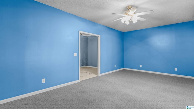 spare room featuring ceiling fan, carpet flooring, and a textured ceiling