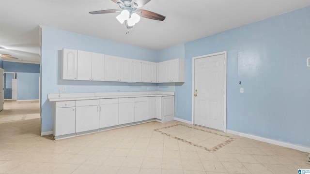 kitchen with ceiling fan and white cabinets