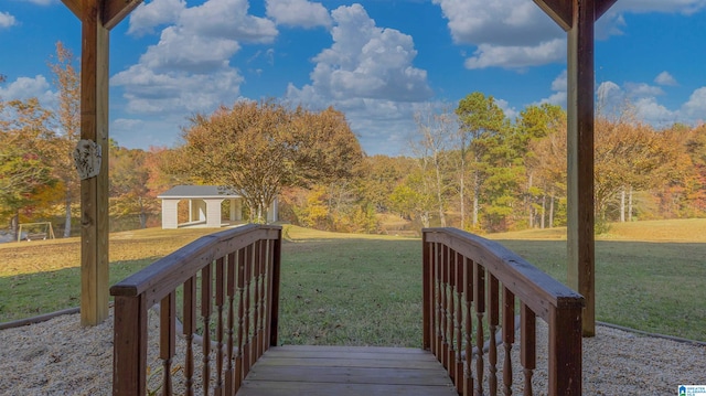 wooden terrace with a lawn