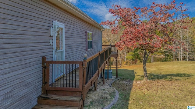 view of home's exterior with a deck and a yard