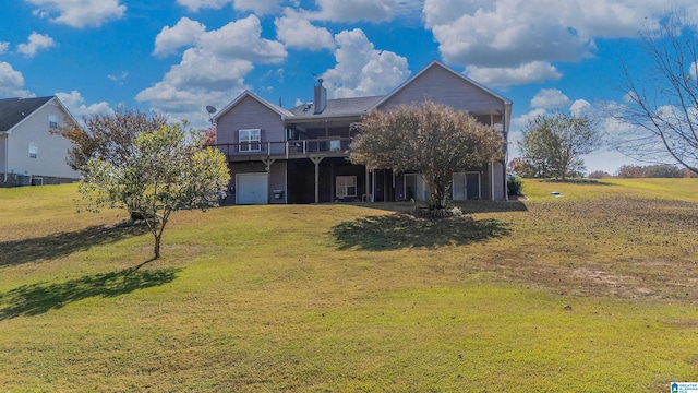 rear view of house featuring a yard