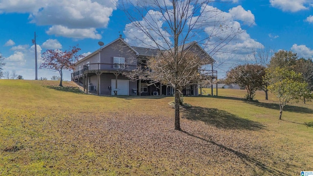 back of property with a wooden deck and a yard