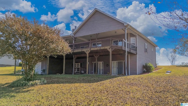 rear view of house featuring a lawn