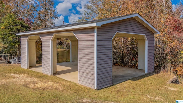 view of outbuilding with a lawn