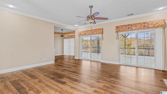 empty room featuring crown molding, hardwood / wood-style floors, ceiling fan, and a wealth of natural light