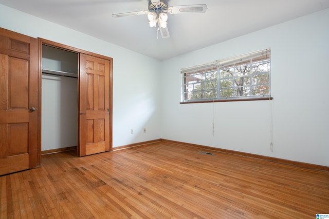 unfurnished bedroom featuring a closet, light hardwood / wood-style floors, and ceiling fan