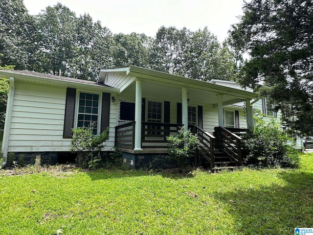 view of front of house with a front yard and covered porch