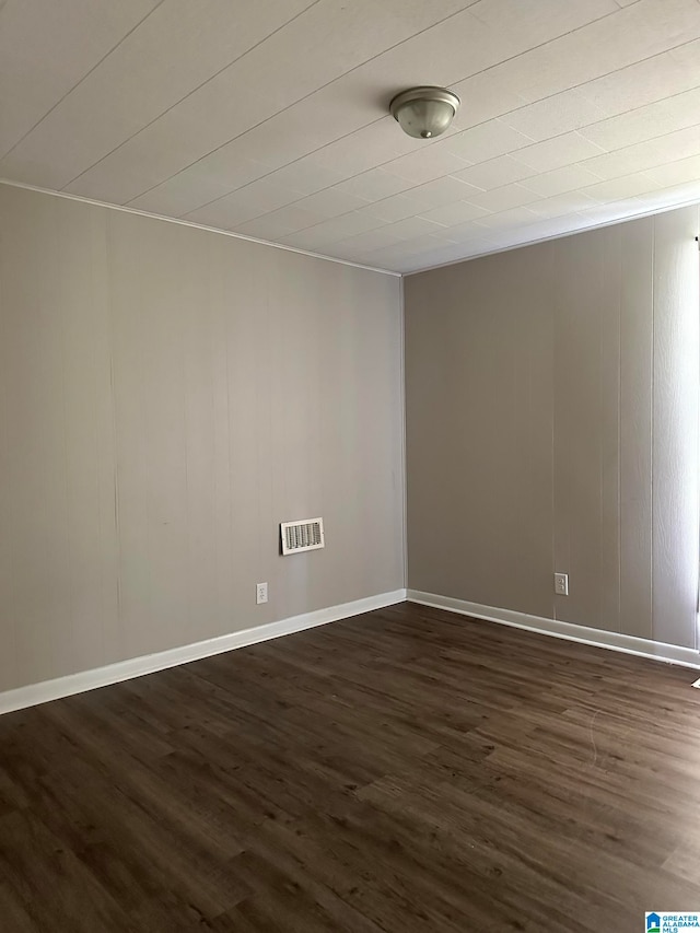 empty room with dark wood-type flooring