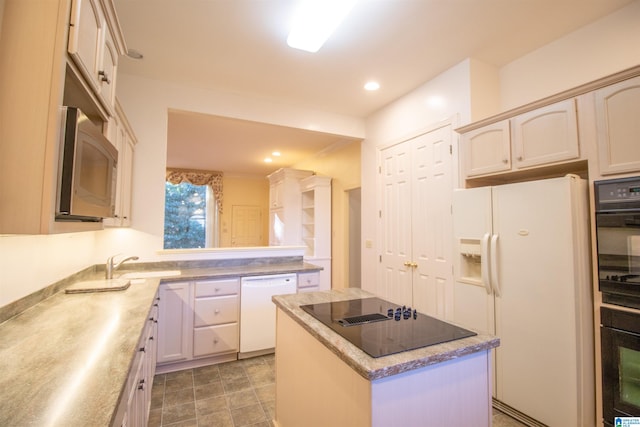 kitchen with white appliances, sink, and a kitchen island