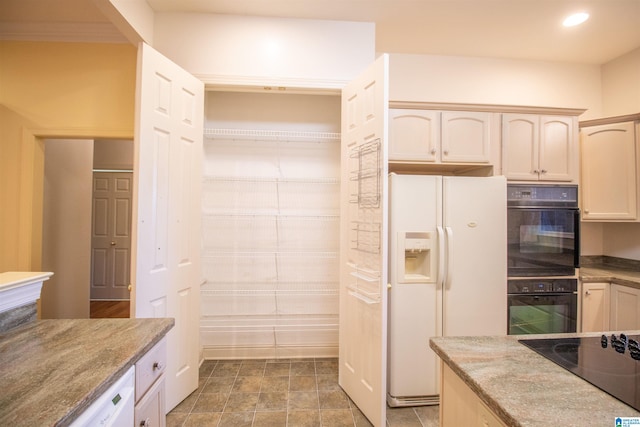 kitchen with black appliances and light stone countertops