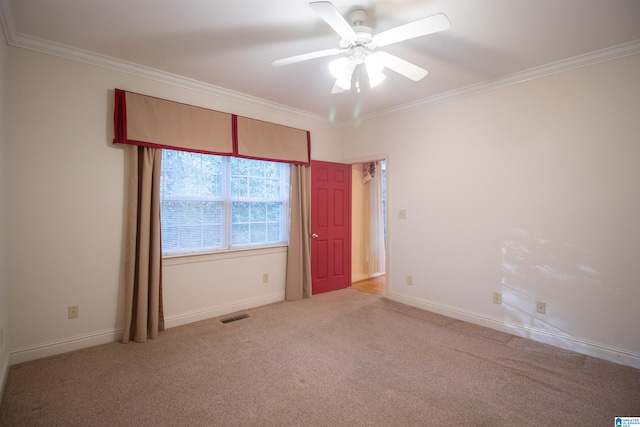 empty room featuring ornamental molding, light colored carpet, and ceiling fan