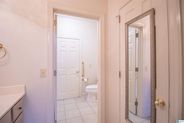 bathroom featuring vanity, tile patterned flooring, and toilet